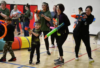 Mothers and Sons in a nerf war battle