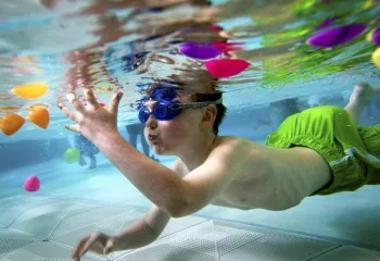 Swimmer under water with eggs floating around