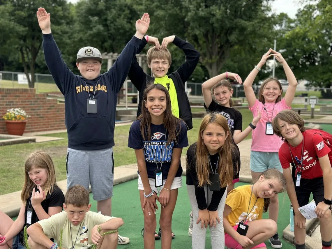 Kids in group making YMCA letters with arms